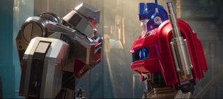 a silver robot faces off against a blue and red robot