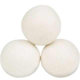 Three round white wool dryer balls in a small pyramid formation