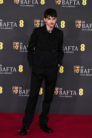 Timothée Chalamet attends the 2025 EE BAFTA Film Awards at The Royal Festival Hall on February 16, 2025 in London, England wearing a bottega veneta suit.