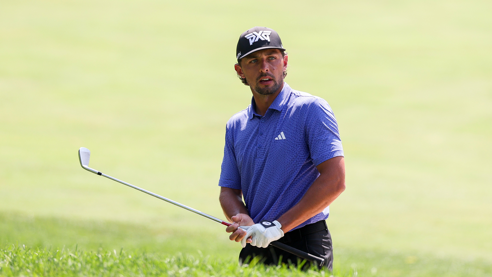 Marco Penge hits an iron shot into the green