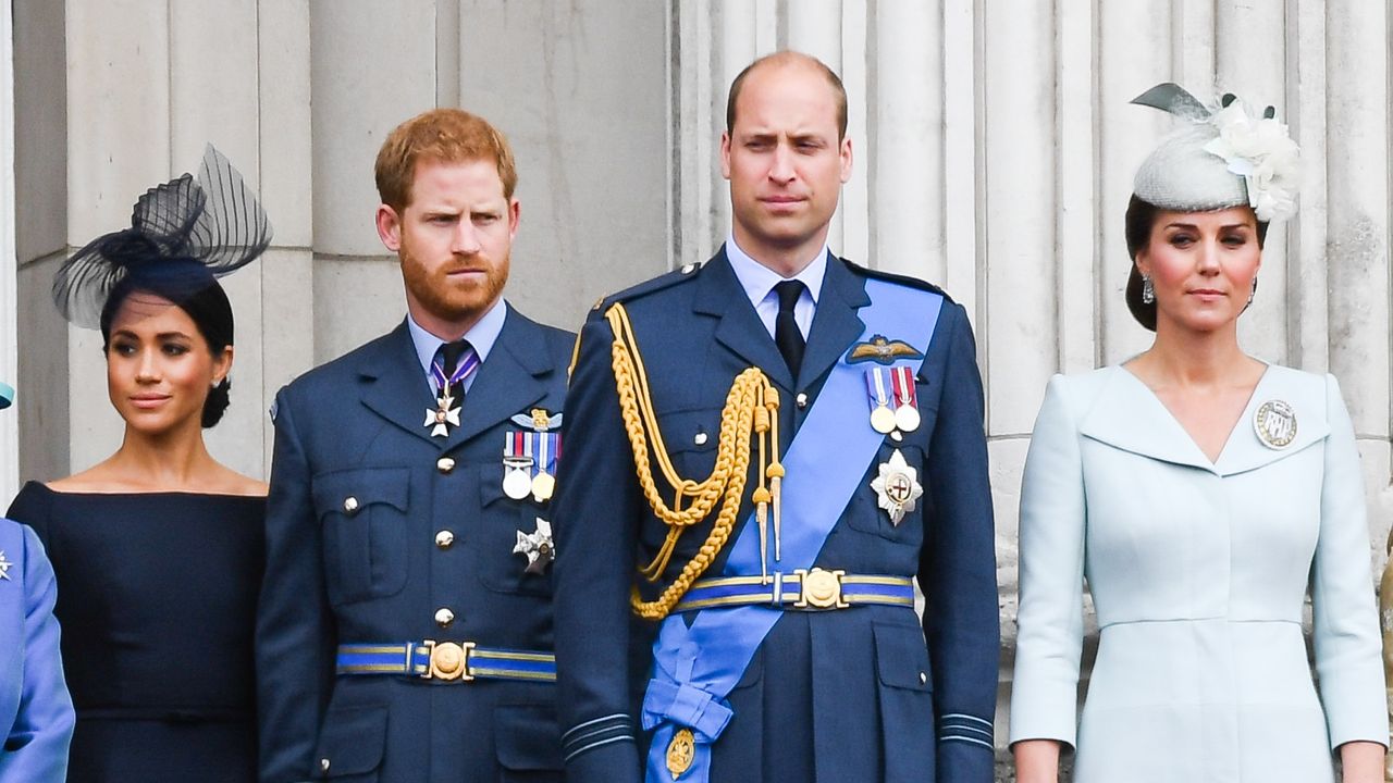 Meghan, Duchess of Sussex, Prince Harry, Duke of Sussex, Prince William, Duke of Cambridge and Catherine, Duchess of Cambridge stand on the balcony of Buckingham Palace to view a flypast to mark the centenary of the Royal Air Force (RAF) on July 10, 2018 in London, England