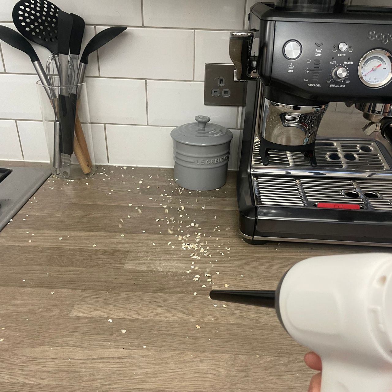 Using the Lakeland 3-in-1 Mini Vacuum Cleaner to suck up porridge oats on a kitchen counter