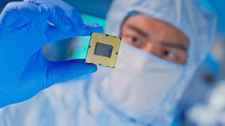 a man holds up a computer chip