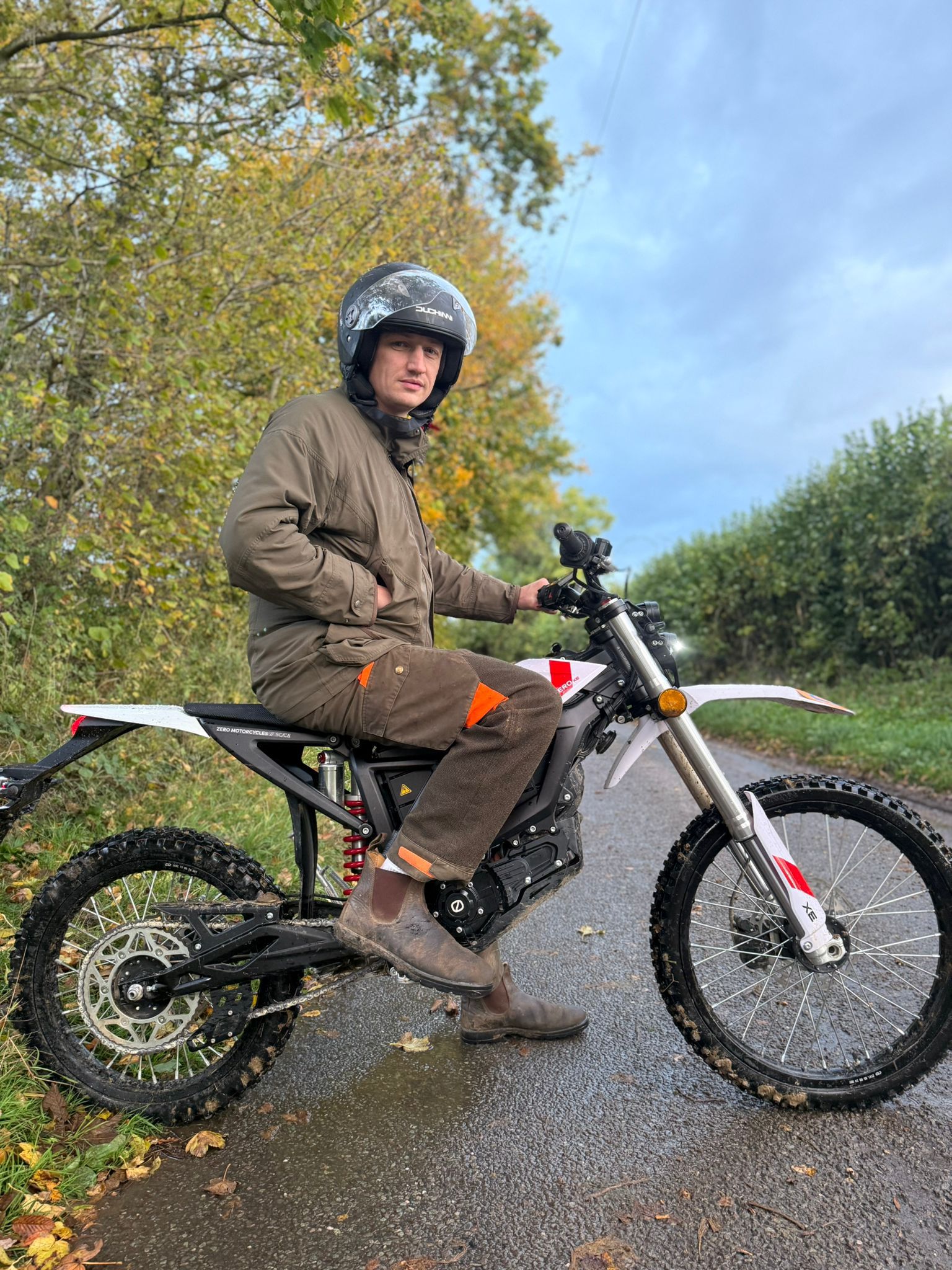 The Author atop the Zero XE, wearing a helmet and chainsaw trousers
