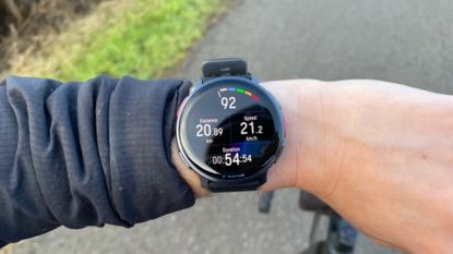 Female cyclist wearing the Polar Vantage V3 smartwatch