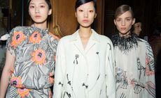 Models wear floral printed dresses and suit in pastel tones, feather collar and matching make-up