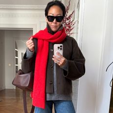 Irene Kim wearing a red scarf, a jacket, and a bag 