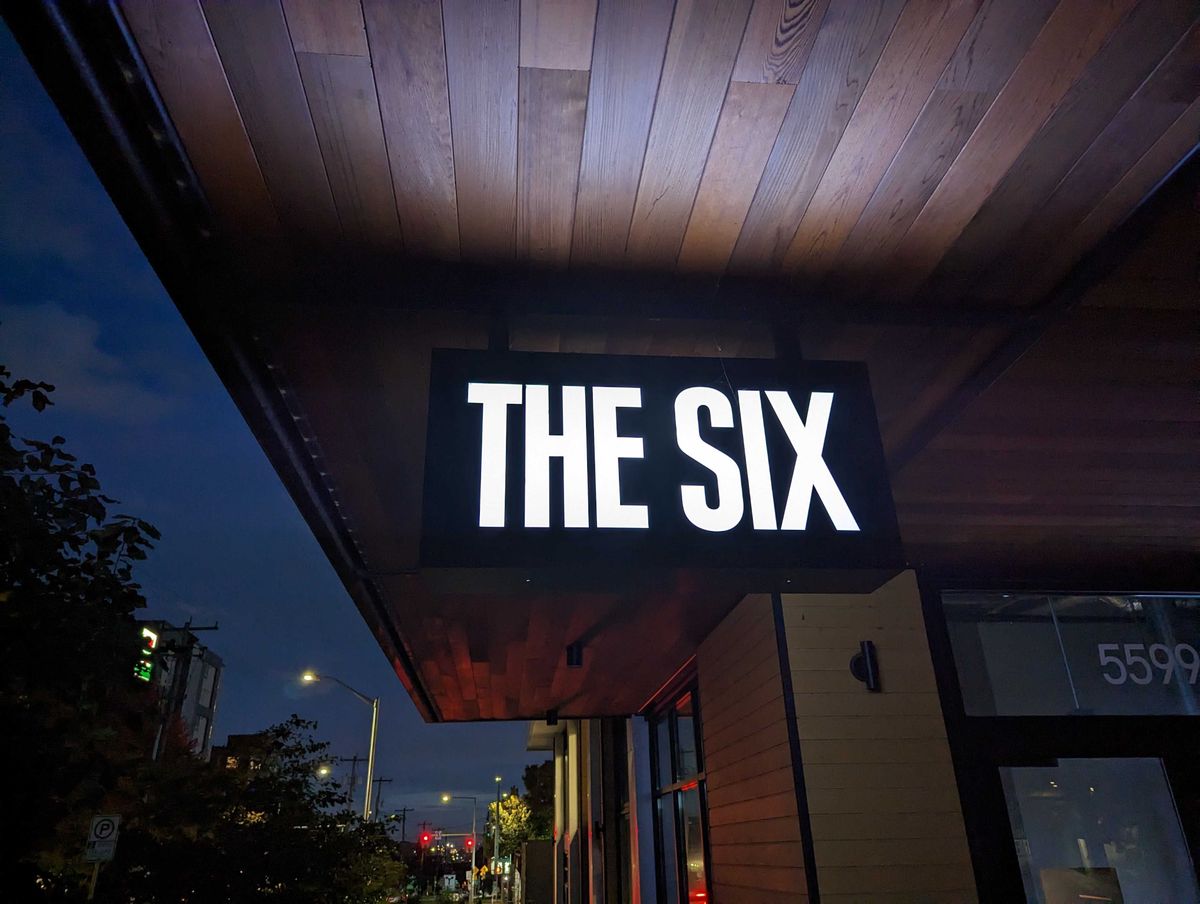 A sign illuminated at night