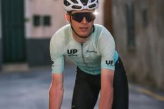 Cyclist on bike in custom owayo kit