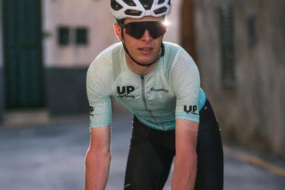 Cyclist on bike in custom owayo kit
