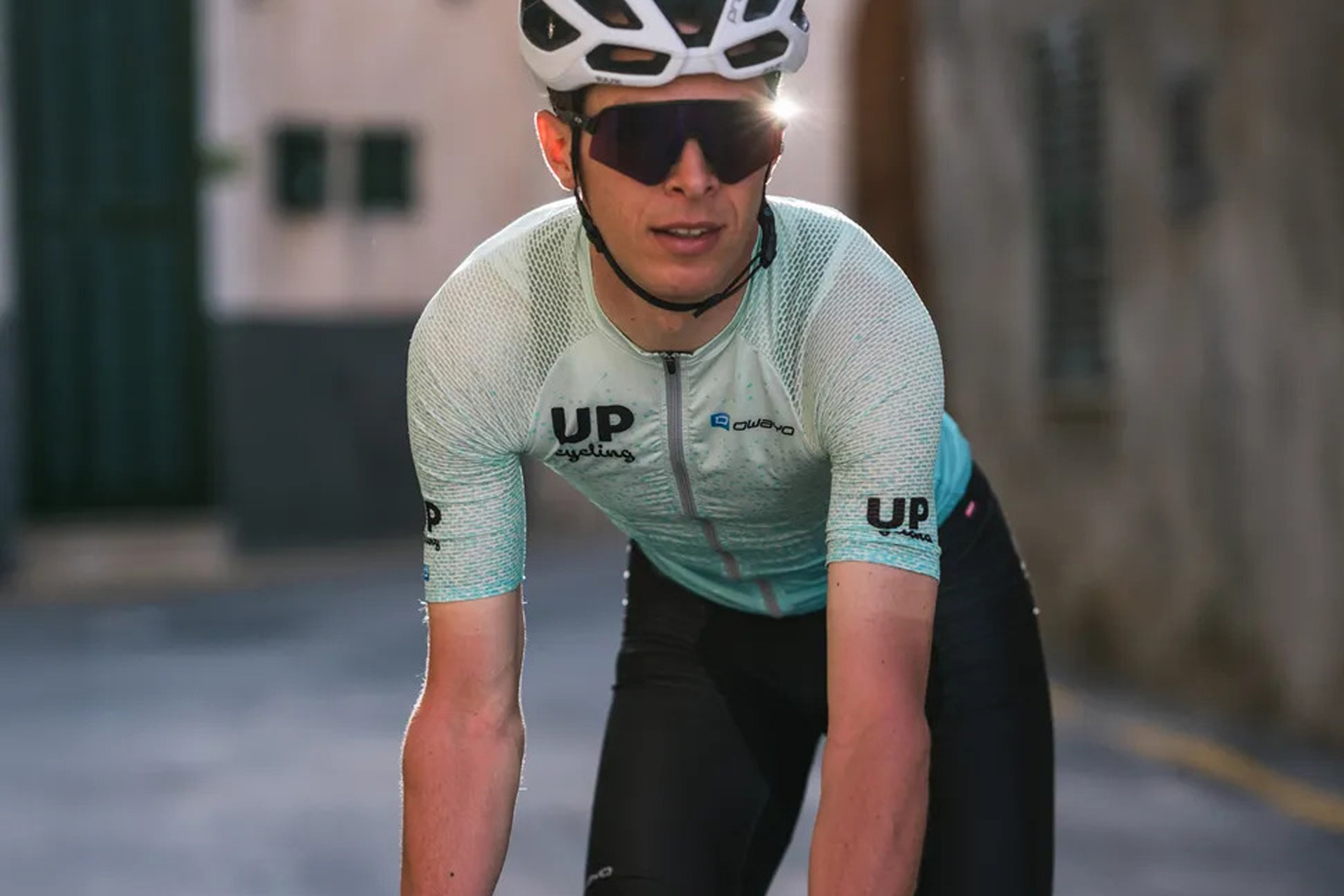 Cyclist on bike in custom owayo kit
