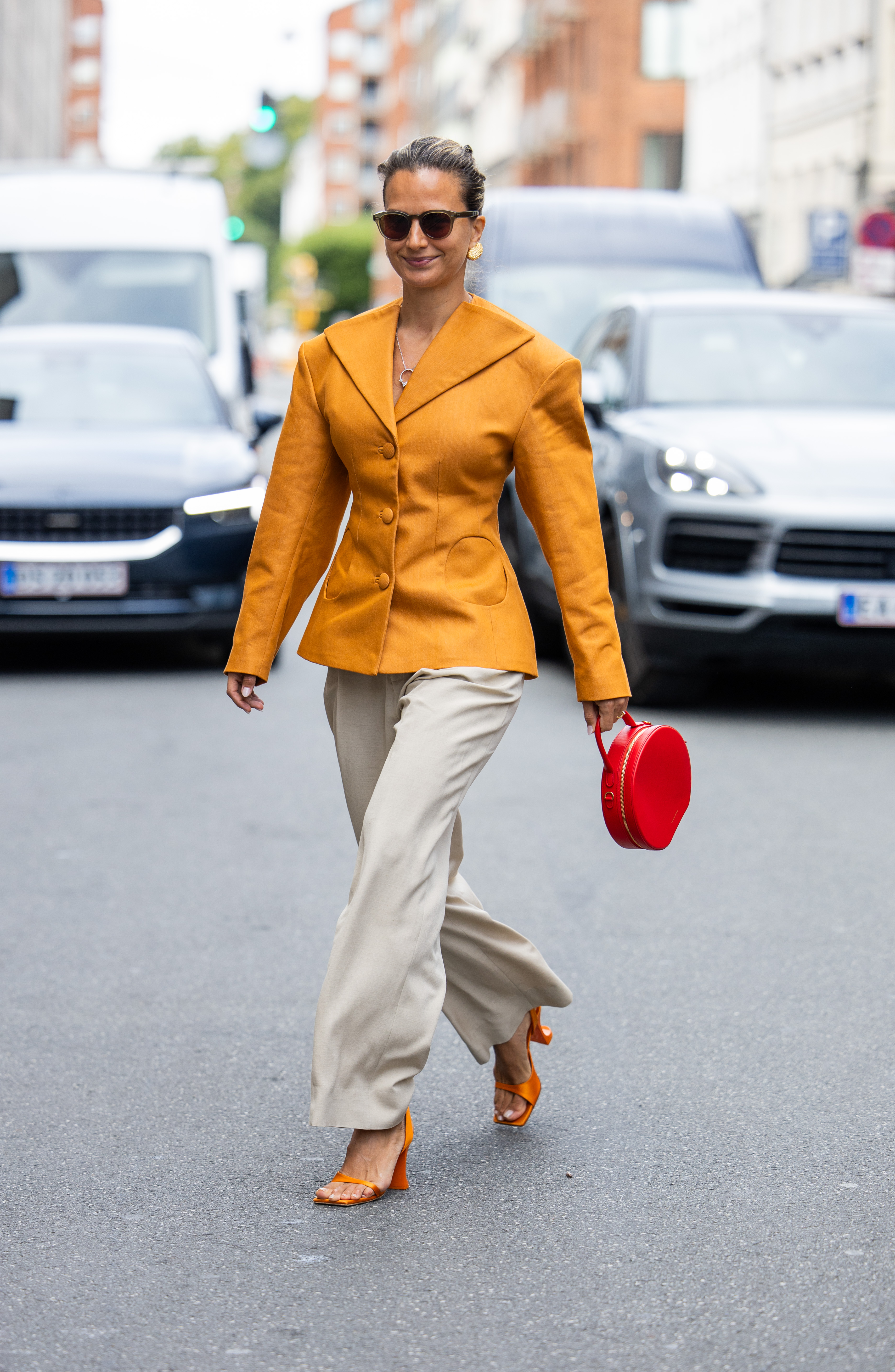 a street style photo of mija knezevic wearing a yellow jacket