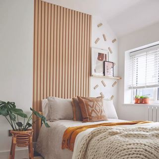 bedroom with wood wall panelling and neutral decor