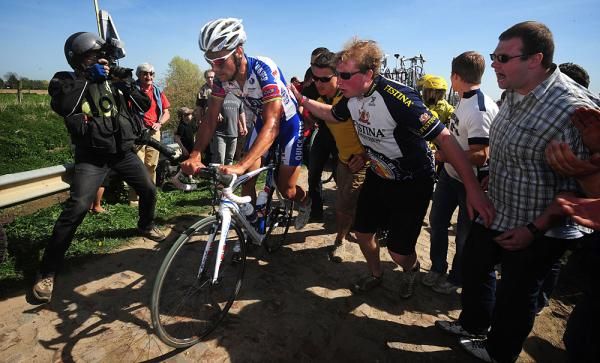 Photographers snapping, fans shouting, Boonen gets pushed back into the action.