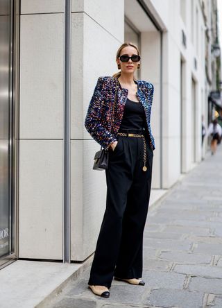 Influencer Alexandra Lapp wearing a sequin embellished blazer with black trousers and Chanel ballerinas at Paris Fashion Week in 2023