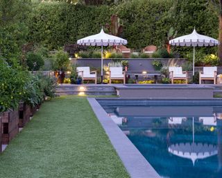Backyard landscaping ideas showing a pool surrounded by two smaller walls with interesting layered planting combinations