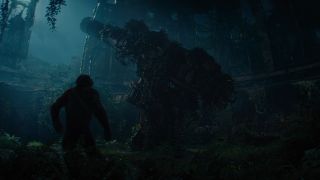 Still from the movie ' Kingdom of the Planet of the Apes' (2024). Silhouette of an ape overlooking a derelict building overgrown with plants and moss.