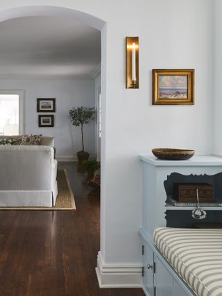 hallway with blue bench and striped cushion