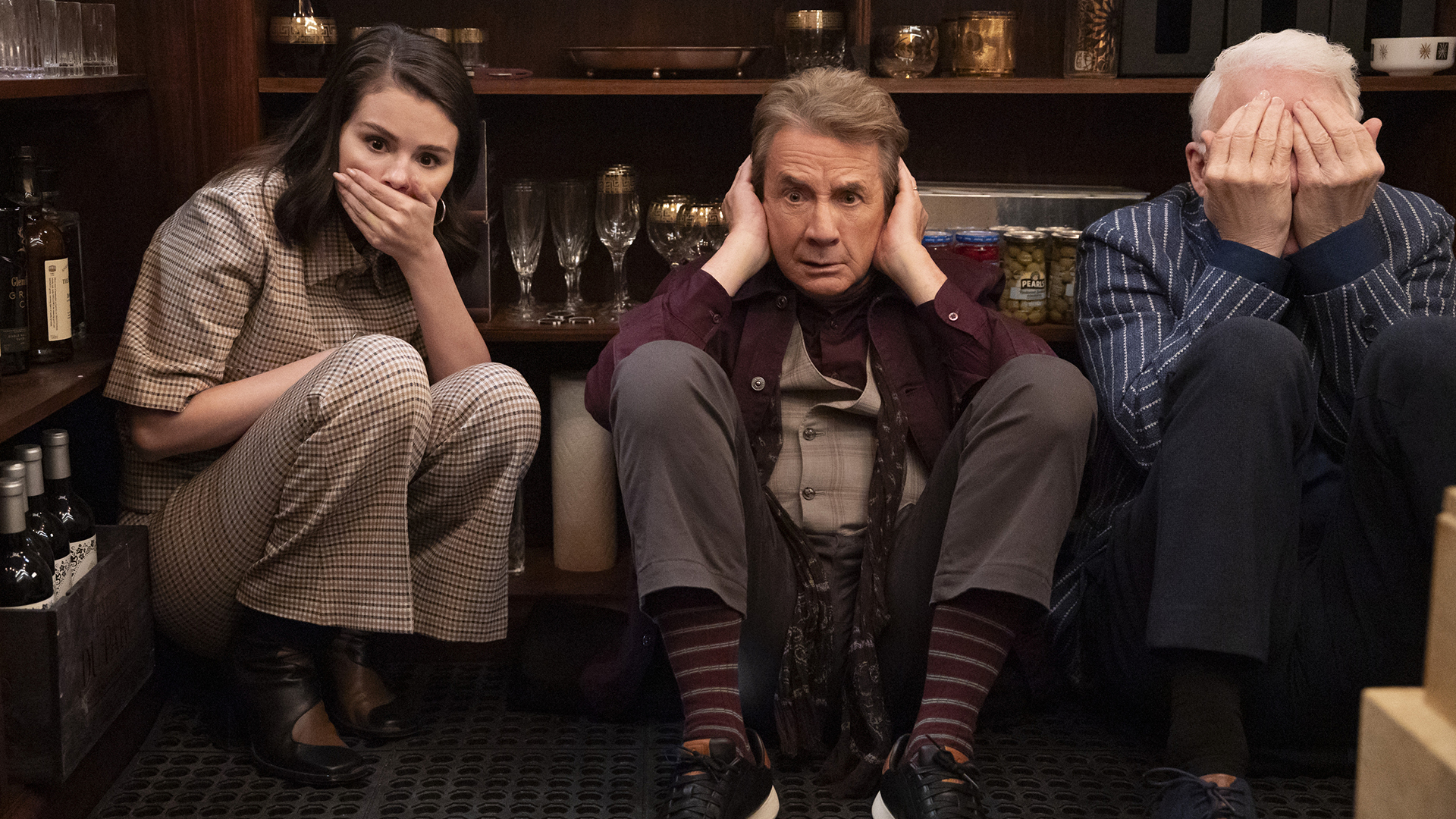 Mabel, Oliver, and Charles-Haden hiding in a storage room in Only Murders in the Building season 5