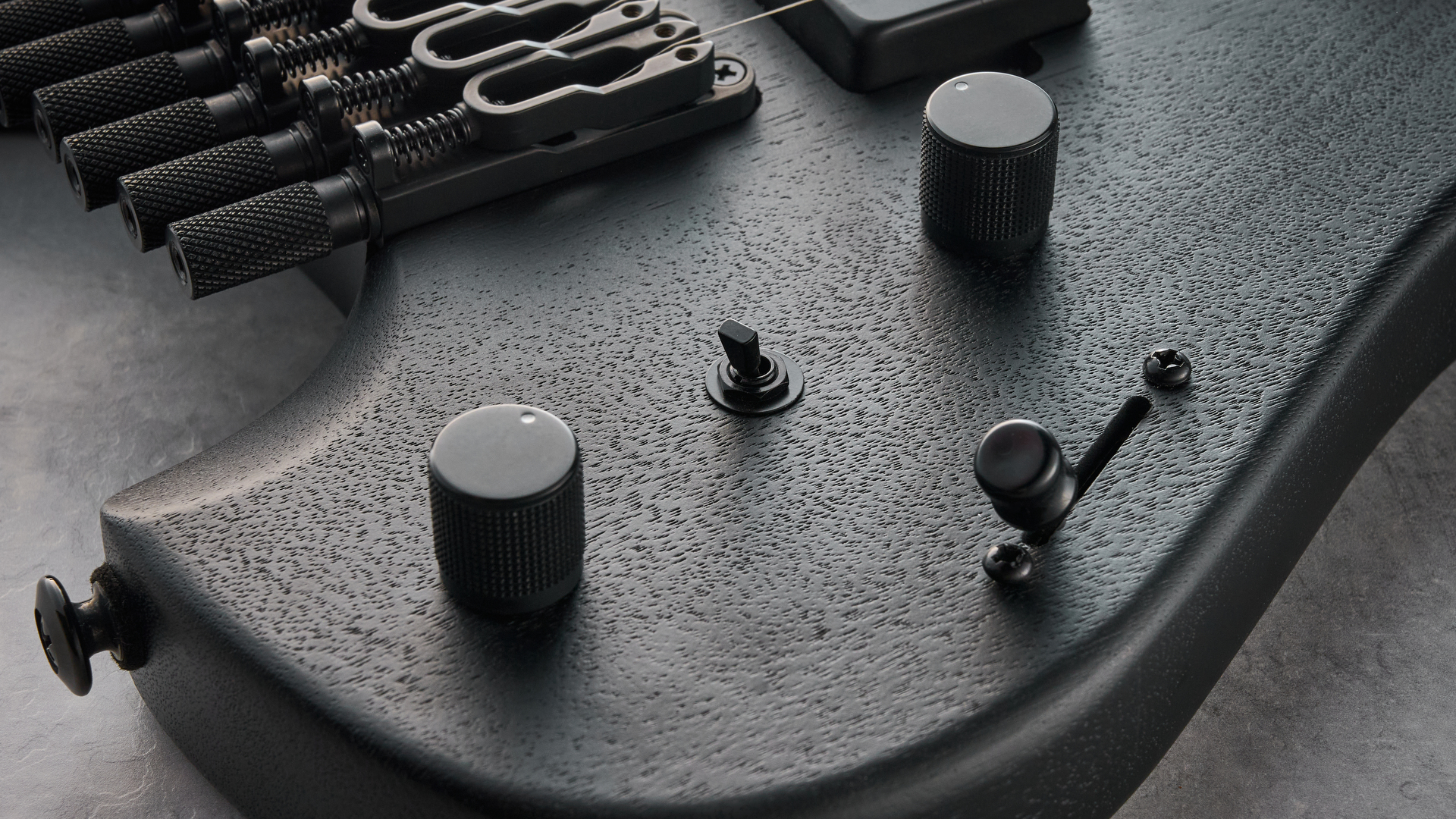 Ibanez QX527B headless guitar shot on grey surface