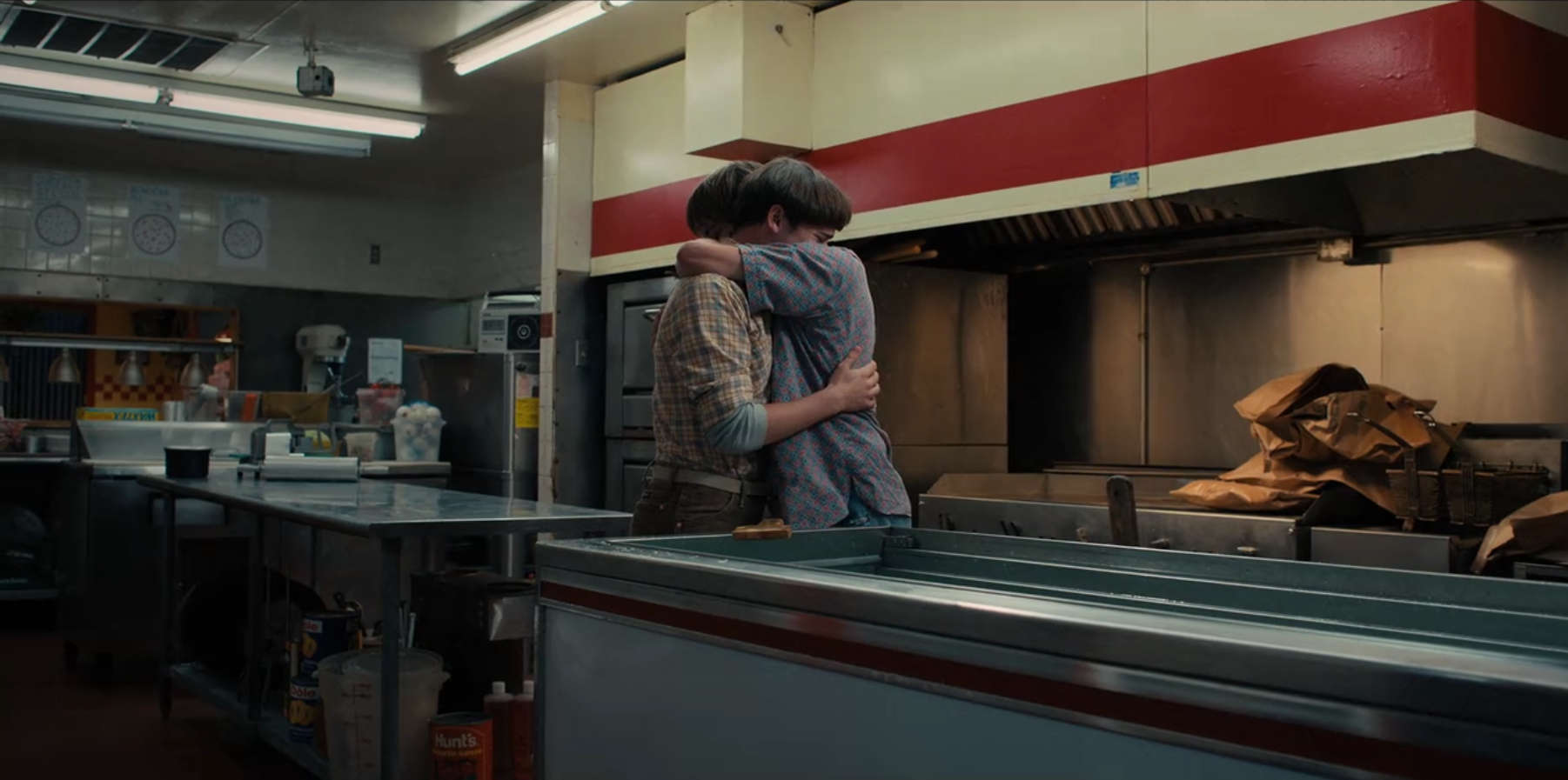 Noah Schnapp and Charlie Heaton as Will and Jonathan, embracing in Stranger Things