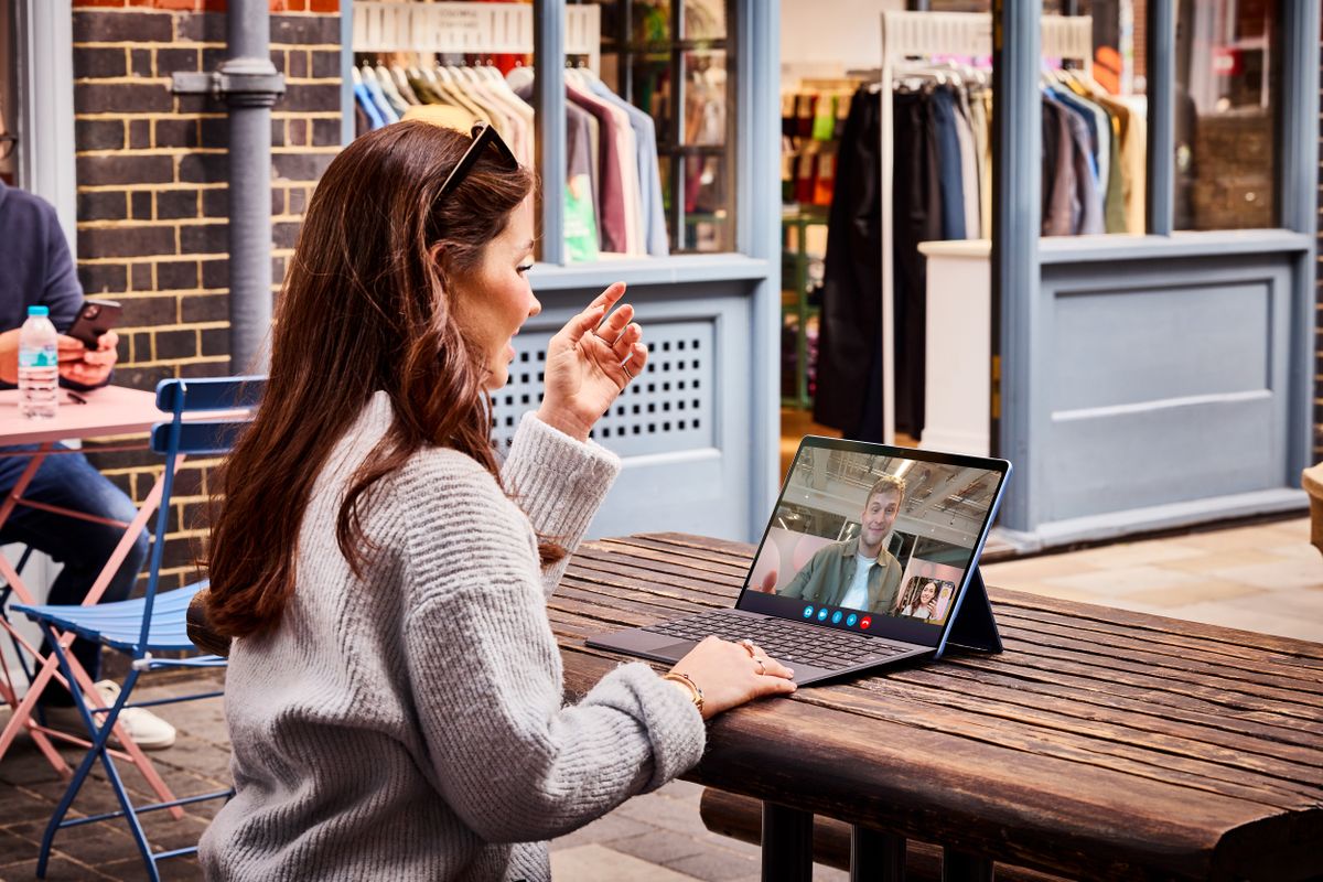 Person sitting at a table using Surface Pro device