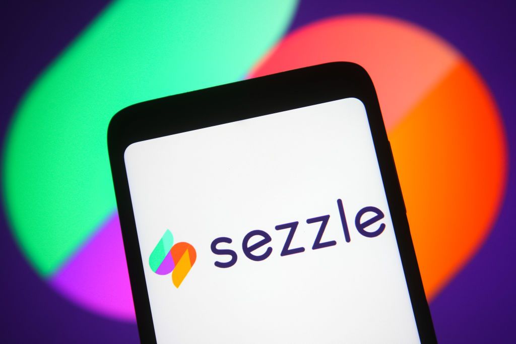 Sezzle logo is displayed on a smartphone screen.