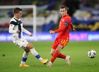 Finland’s Robin Lod and Gareth Bale battle for the ball in Cardiff