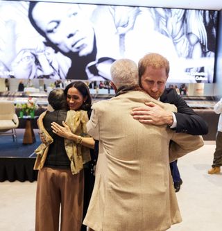 Meghan Markle and Prince Harry hug patrons of the Kinsey collection