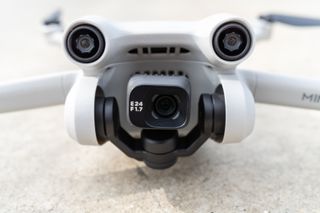 The DJI Mini 3 Pro drone resting on the ground