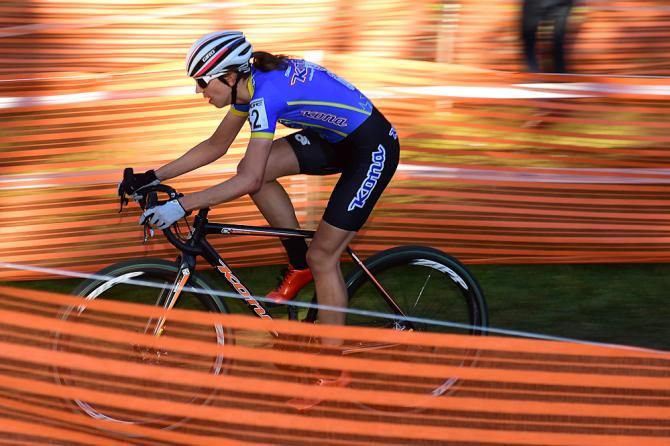 Helen Wyman (Kona) racing in a sea of course tape and fencing
