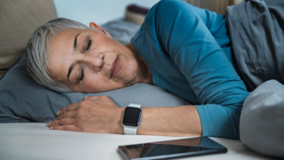 Woman wearing smartwatch while sleeping