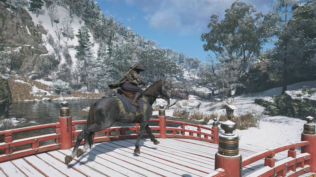 Assassin&#039;s Creed Shadows Naoe riding her horse across a red, snow-covered bridge over a river