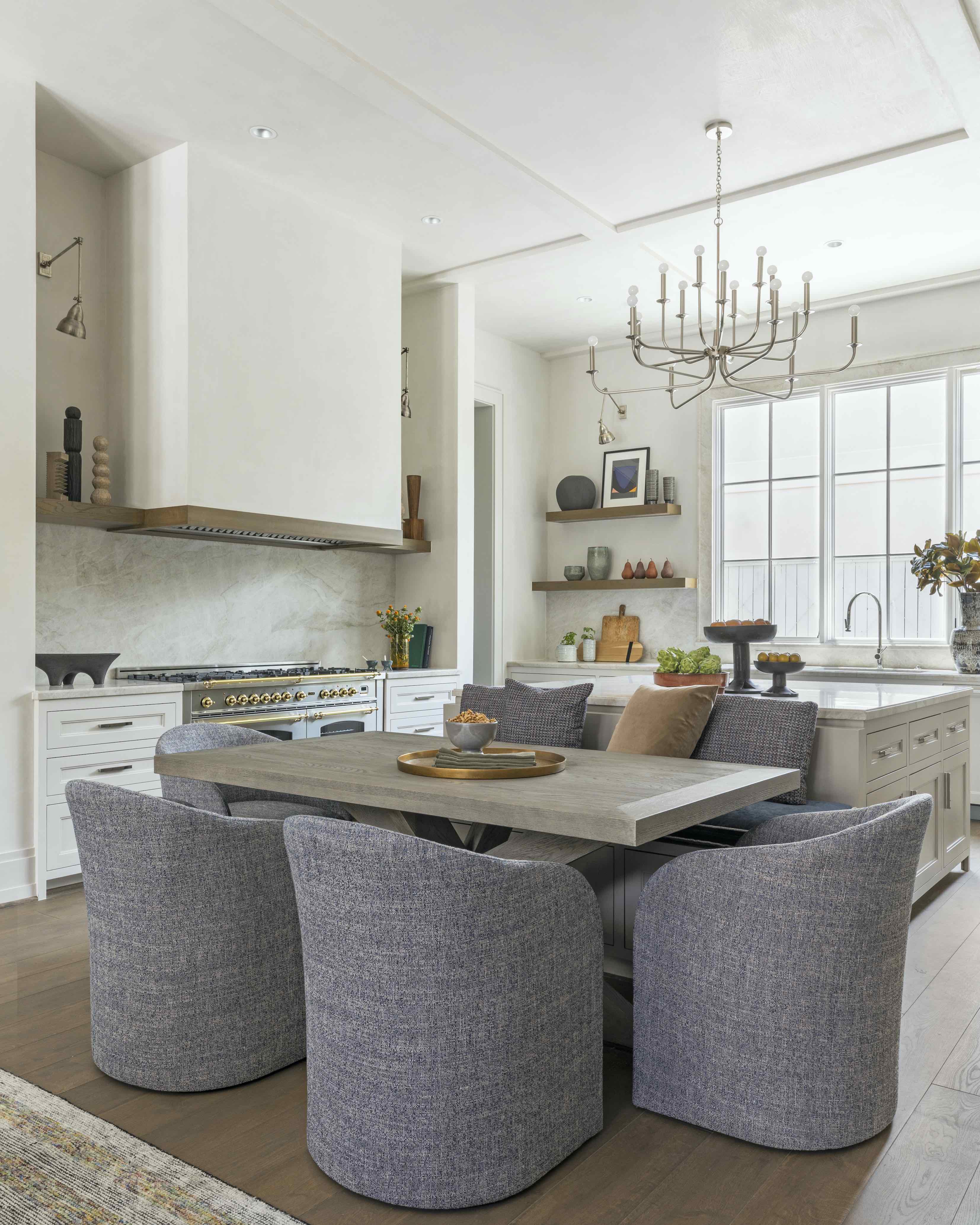 kitchen island with banquette seating and table at the end