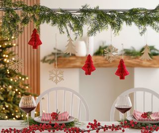 A simple over table display bar with simple real foliage and red paper decorations