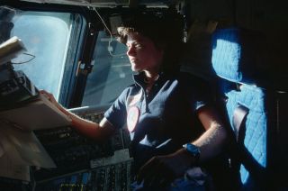 Sally Ride, America's first woman in space, looks out the forward windows of the space shuttle Challenger in June 1983.