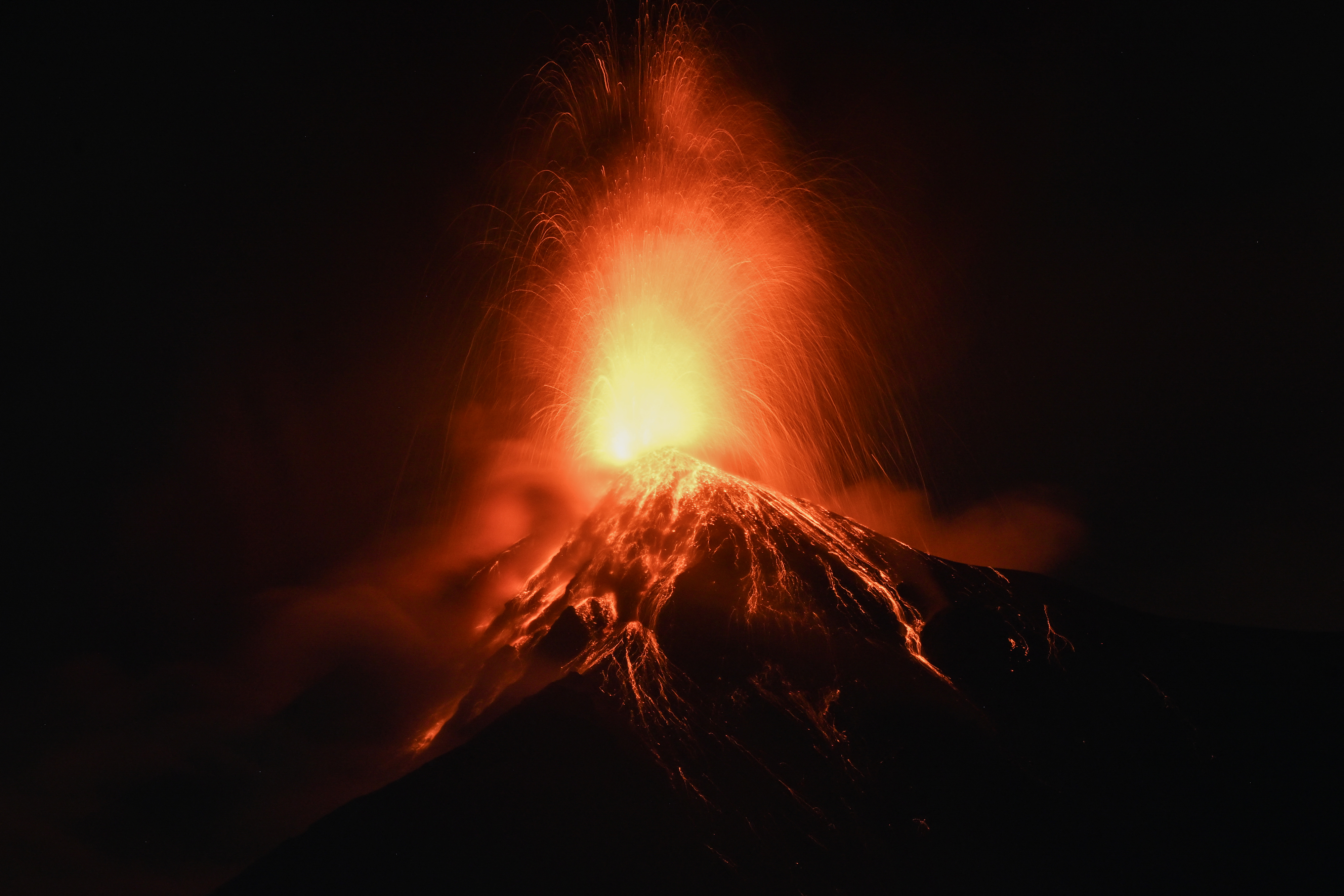 TOPSHOT - Fuego volcano erupts in Alotenango, some 65 kilometers southwest of Guatemala City, early on August 4, 2026. Guatemalan authorities issued the country's second-highest emergency alert level on August 4 after a major eruption of Central America's most active volcano, prompting the evacuation of nearby villages. (Photo by Johan ORDONEZ / AFP via Getty Images)