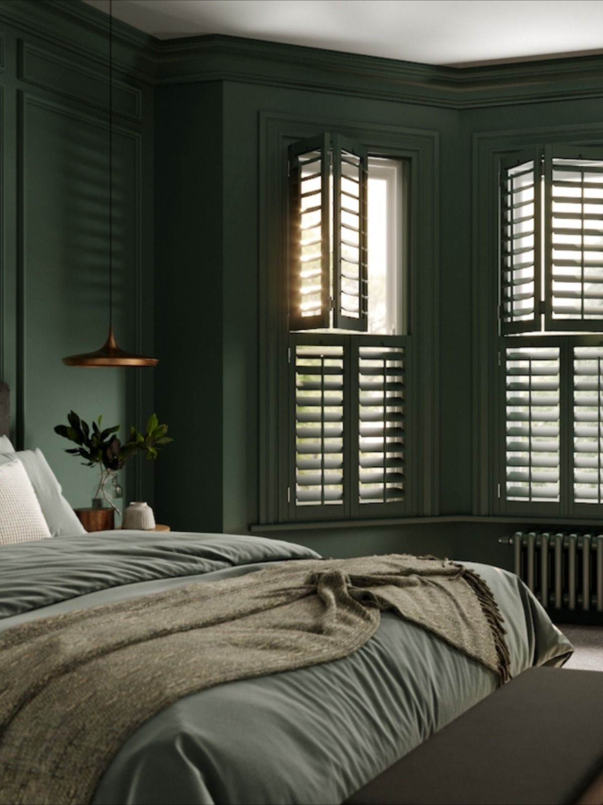 Color drenched dark green bedroom with coordinating plantation shutters