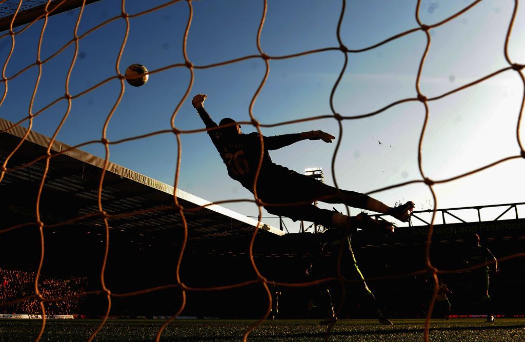  Ali Al Habsi of Wigan Athletic fouls to save a goal during the Barclays Premier League match between Norwich City and Wigan Athletic at Carrow Road on March 11, 2012 in Norwich, England.