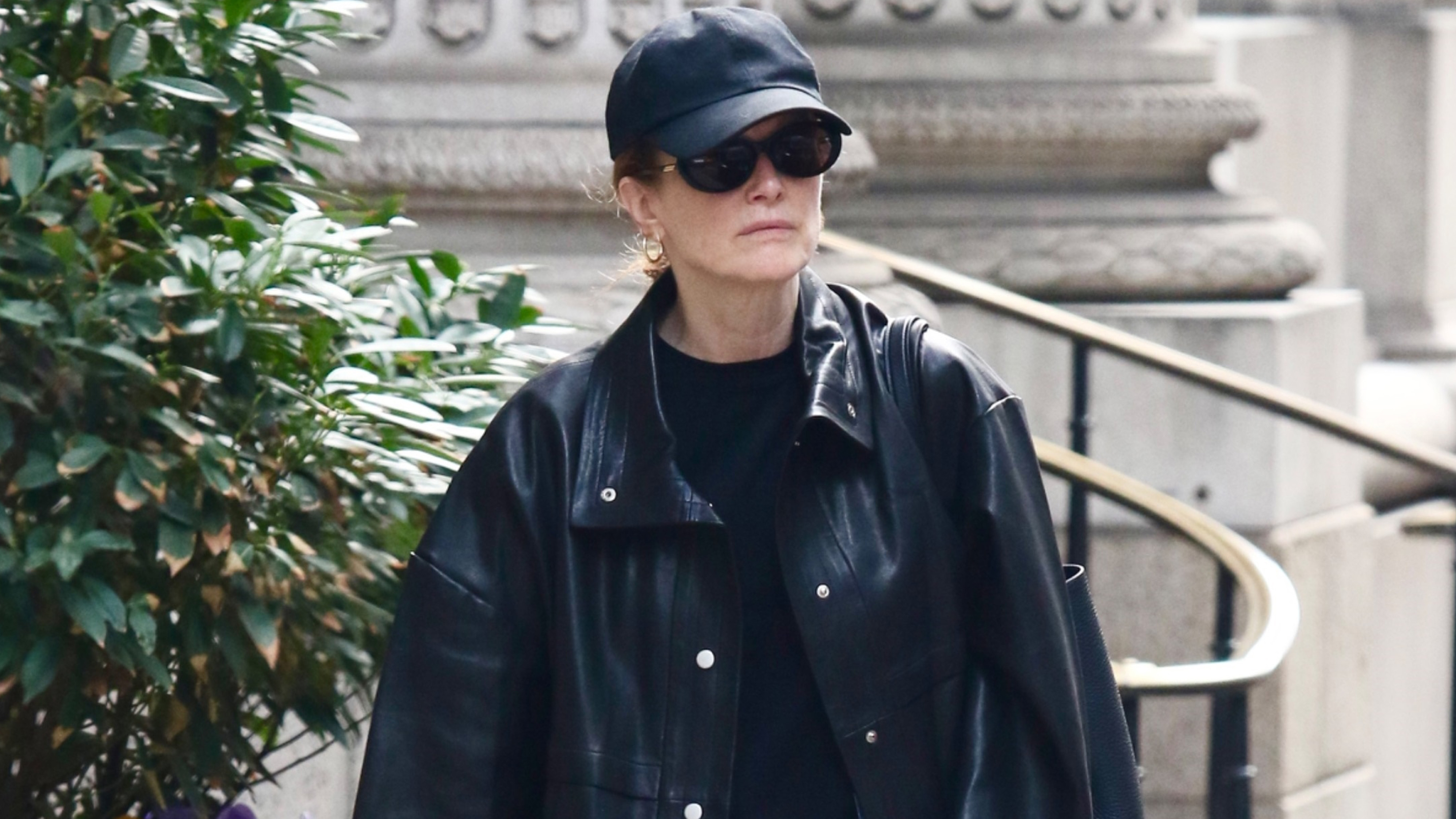 Julianne Moore wears a black hat, black T-shirt, and a black leather jacket.