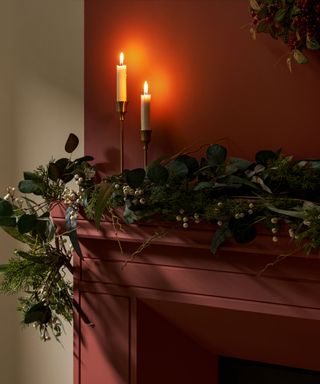 Mantel decorated with candles and foliage