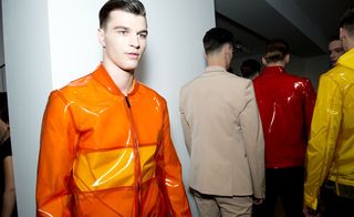 Male modelling orange and yellow jacket