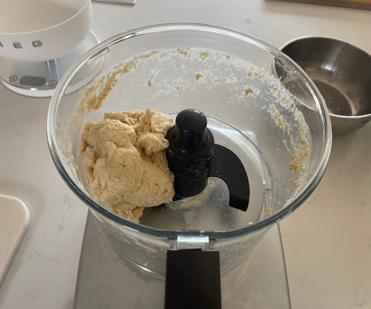 Dough inside the pitcher of a magimix food processor.