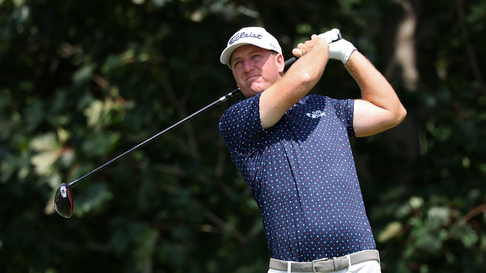 Tom Hoge hits a driver off the tee
