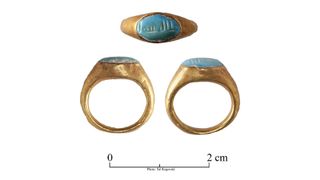 This gold ring contains a turquoise gem with the inscription "Mashallah," which translates as "God has willed it" on it.
