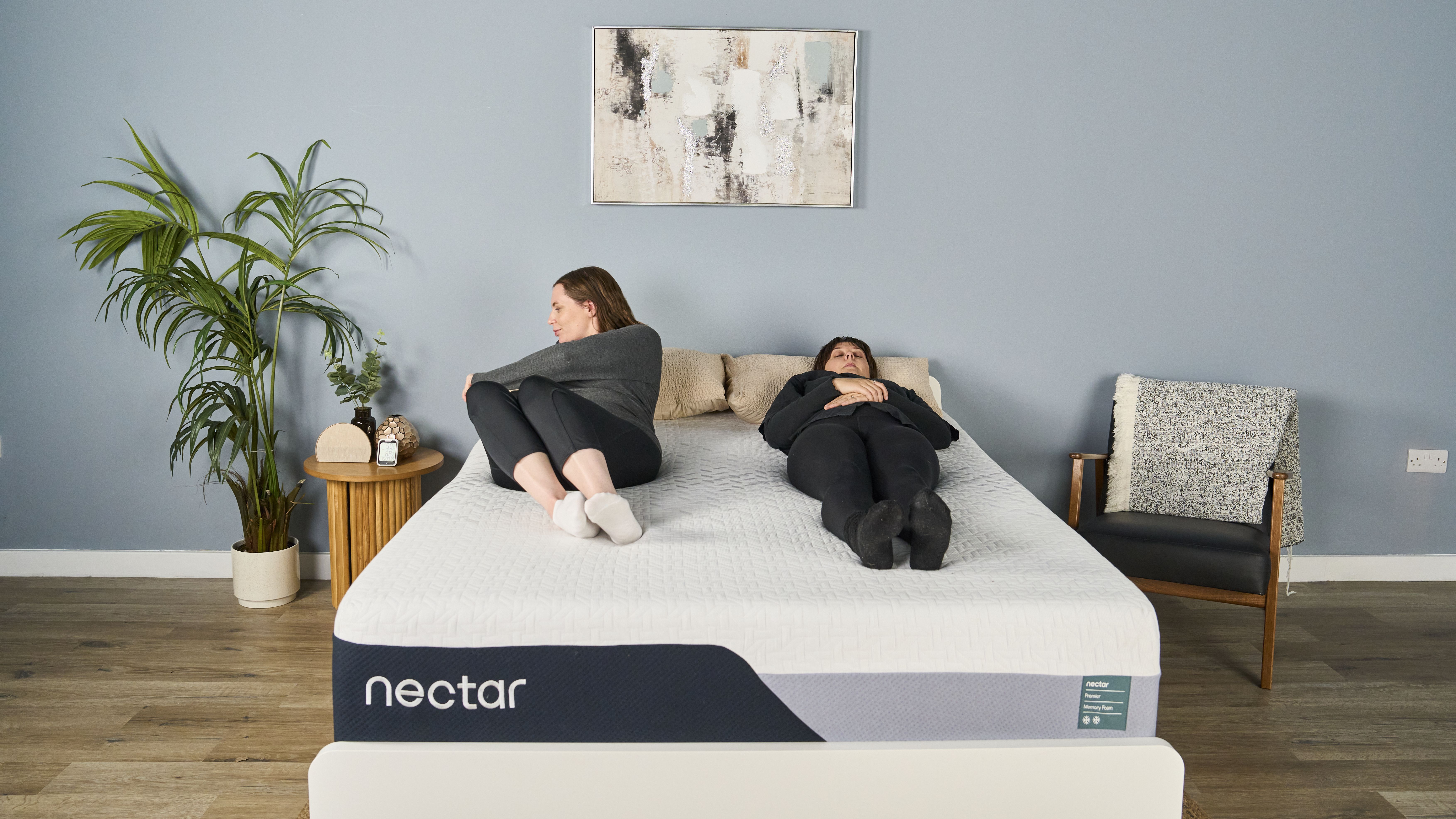 Tester Ruth Jones moves around on the Nectar Premier Memory Foam Mattress while another tester, sleep features editor Lauren Jeffries, lies still next to her.