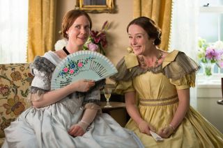 cynthia nixon in a big victorian era dress fanning herself in the movie a Quiet Passion