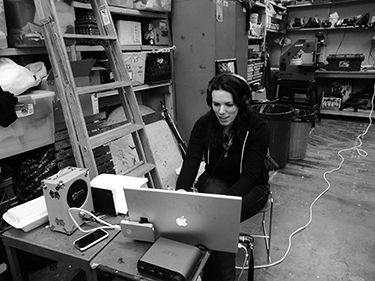 Kari Rae Seekins sits in front of a laptop