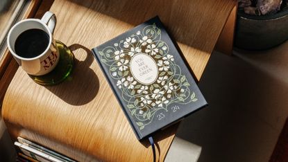 book on a table with a cup of coffee