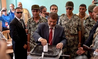 Egypt's presidential candidate, Muslim Brotherhood's Mohamed Morsi casts his ballot Saturday: The former prime minister to Hosni Mubarak won Egypt's first competitive election.